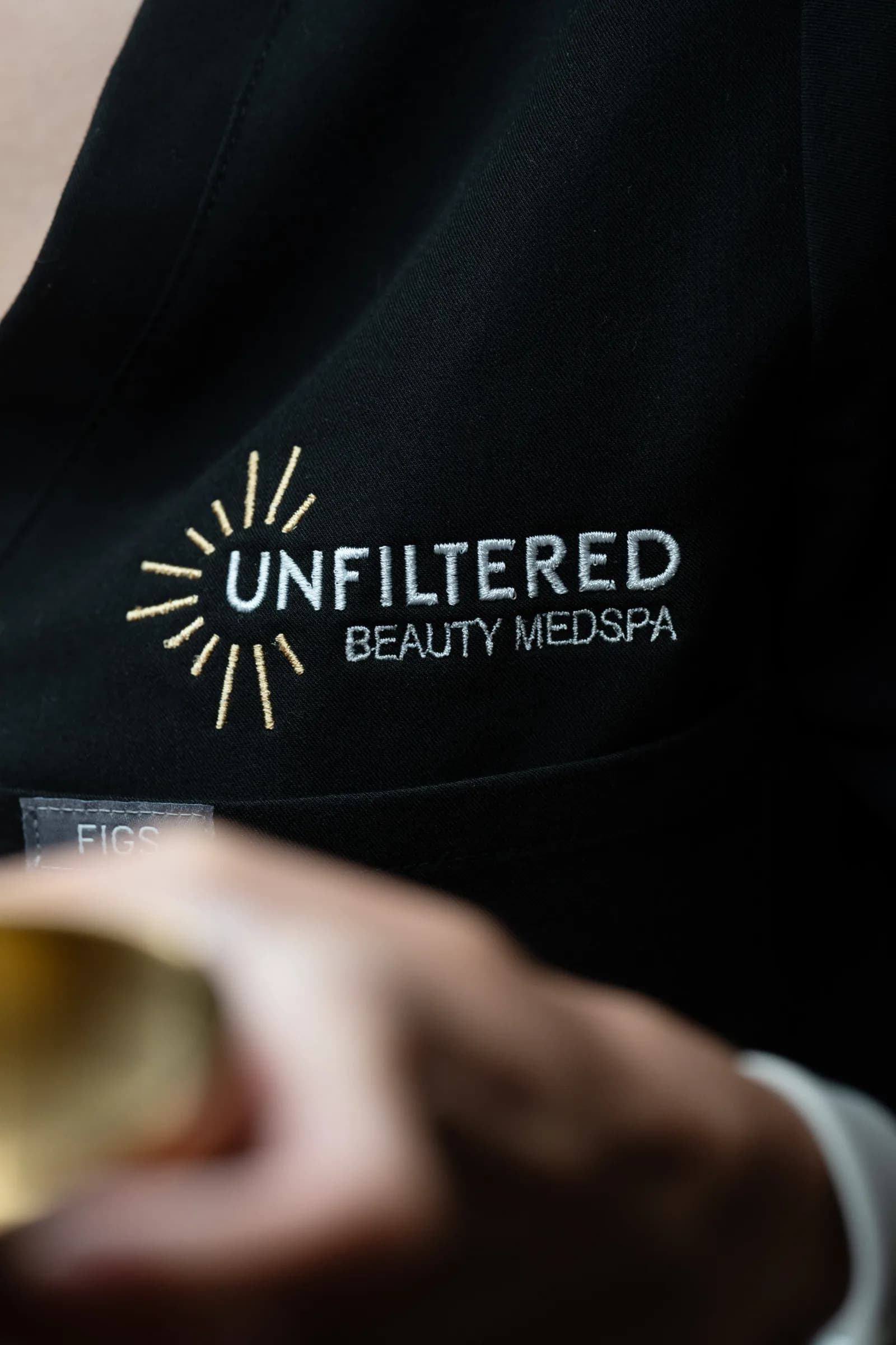 Close detail of the embroidered Unfiltered Beauty MedSpa robe