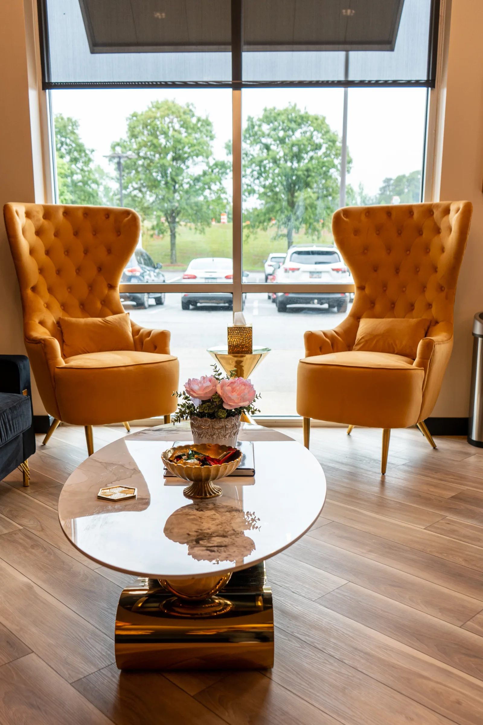 Gold lounge chairs by the window in the waiting area